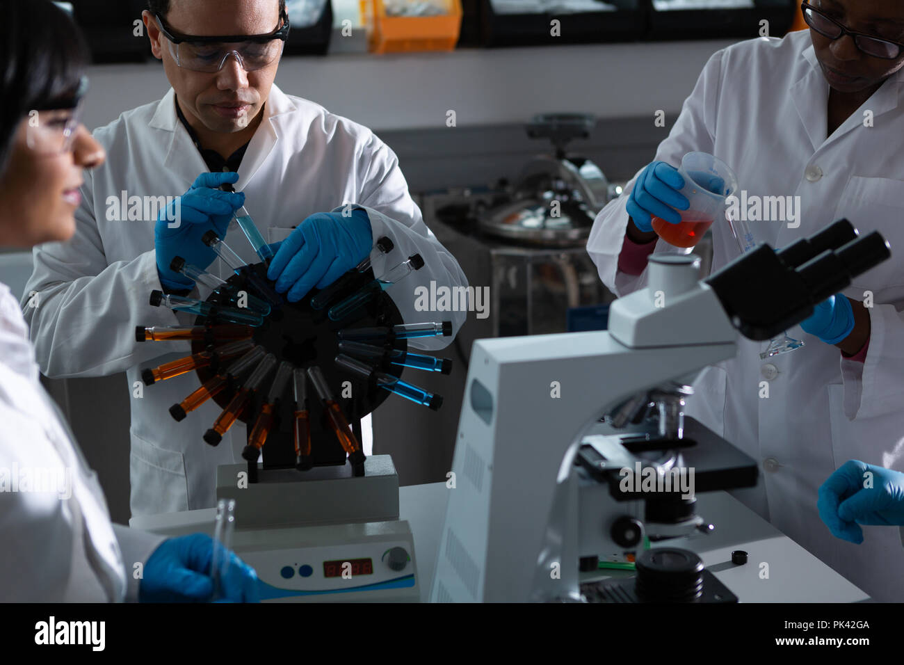 Team of scientists experimenting together Stock Photo