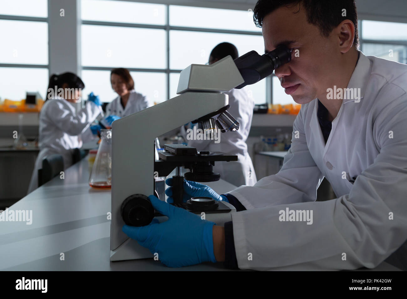 Male scientist using microscope Stock Photo