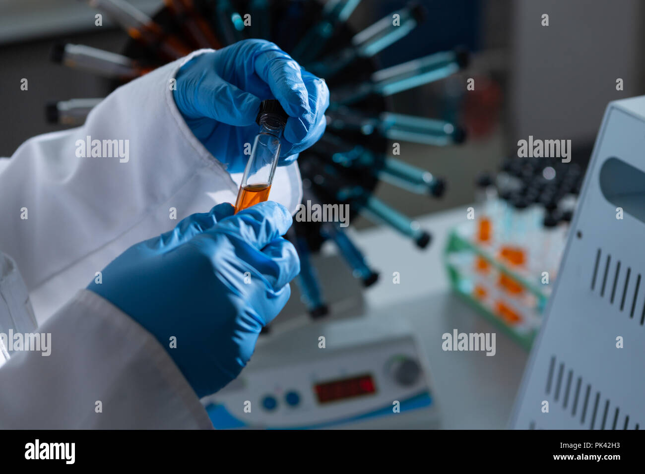 Female scientist examining test tube Stock Photo