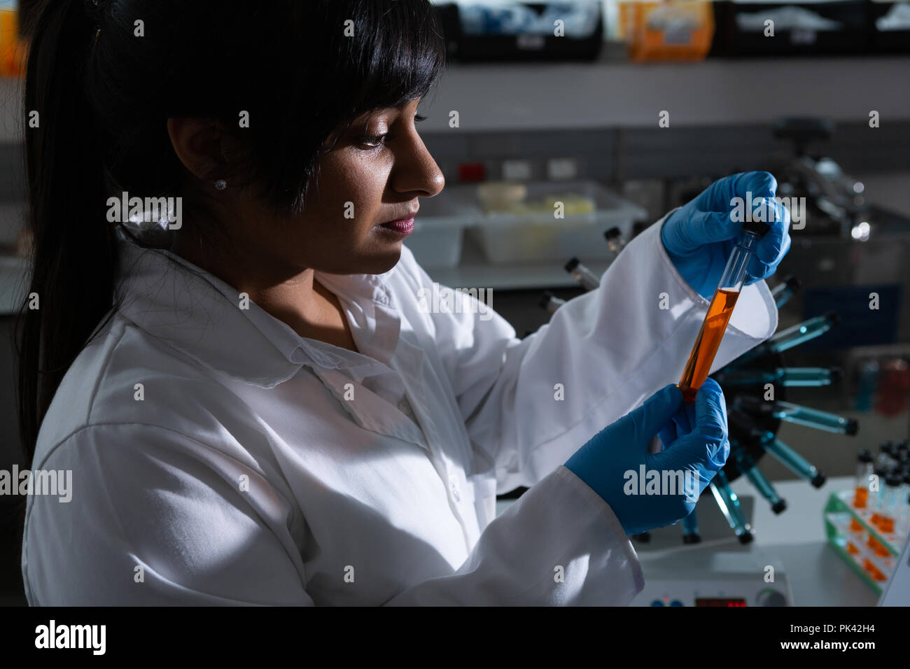 Female scientist examining test tube Stock Photo