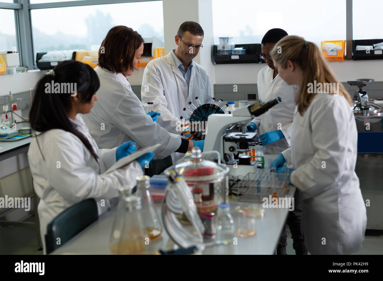 Team of scientists experimenting together Stock Photo