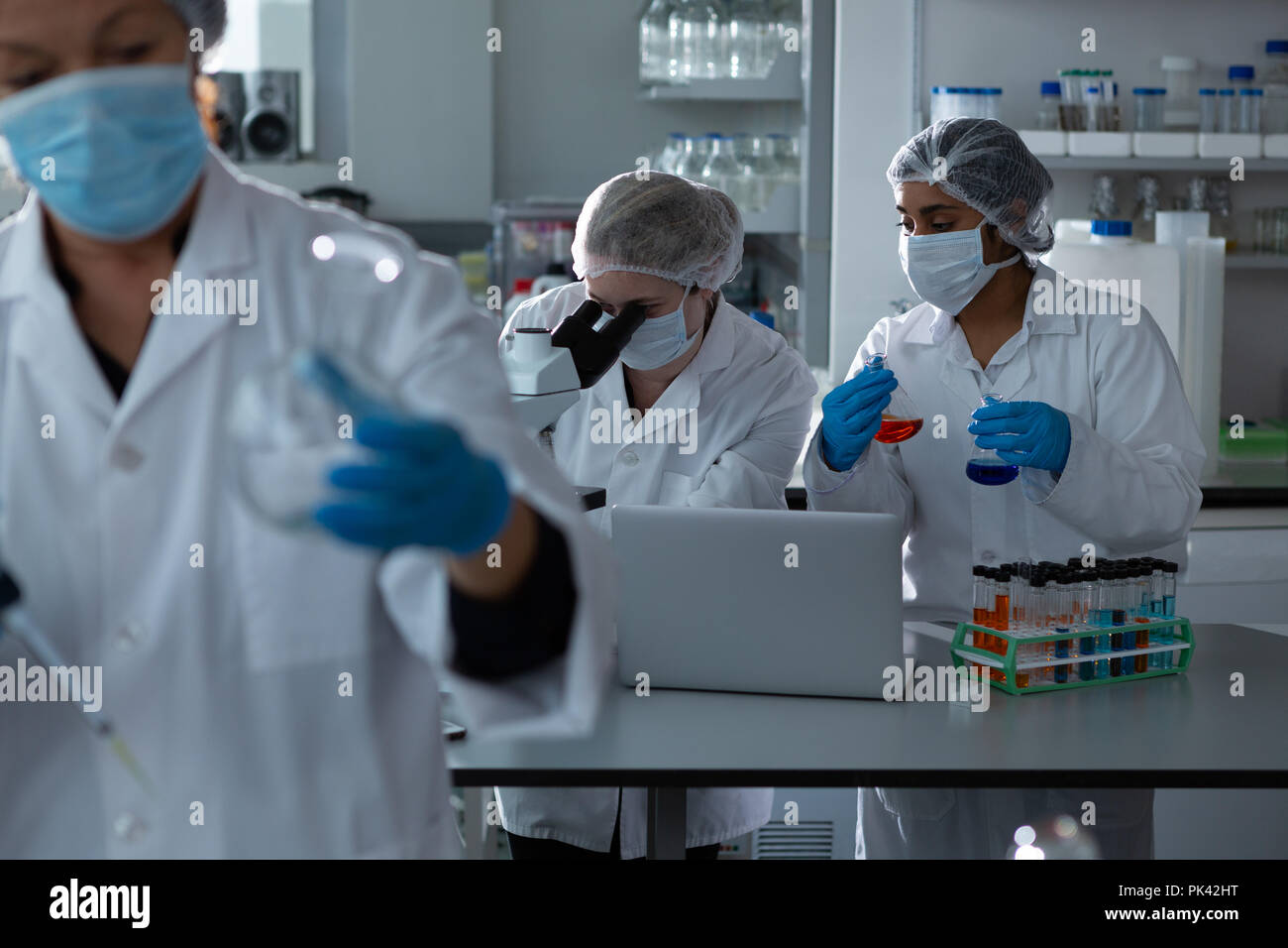Team of scientists experimenting together Stock Photo
