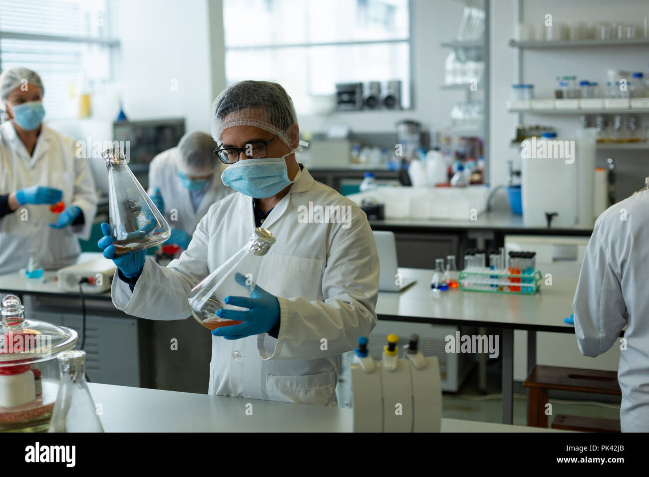 Scientists experimenting in laboratory Stock Photo