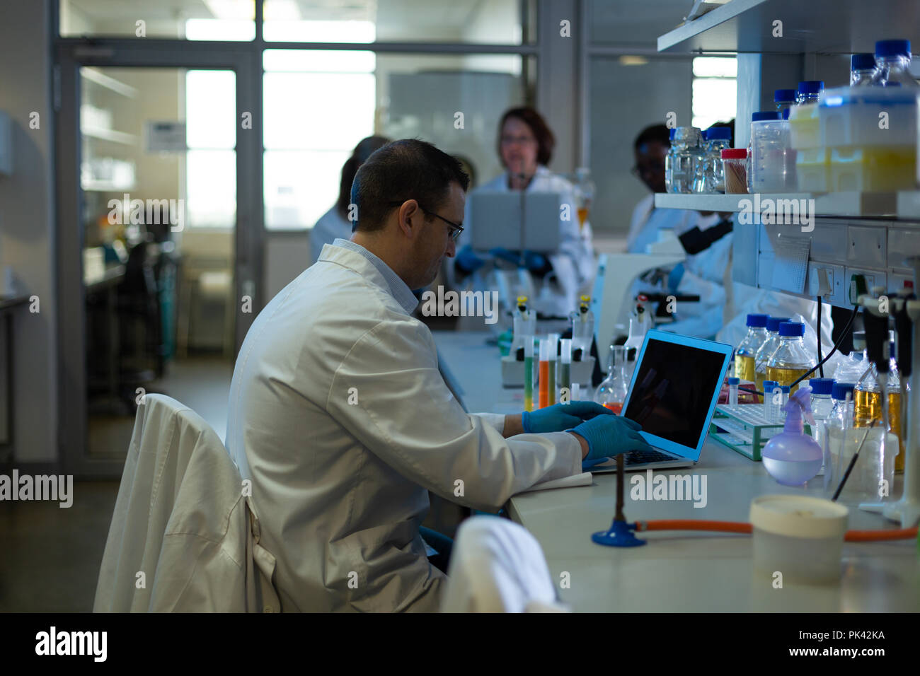 Male scientist using laptop in laboratory Stock Photo