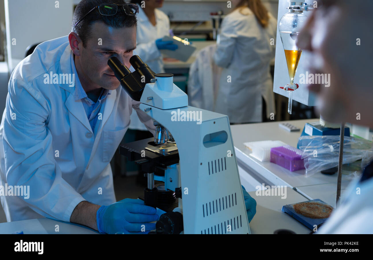 Male scientist using microscope Stock Photo