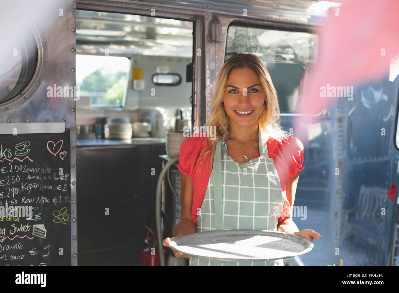 Female waitress standing in food truck Stock Photo