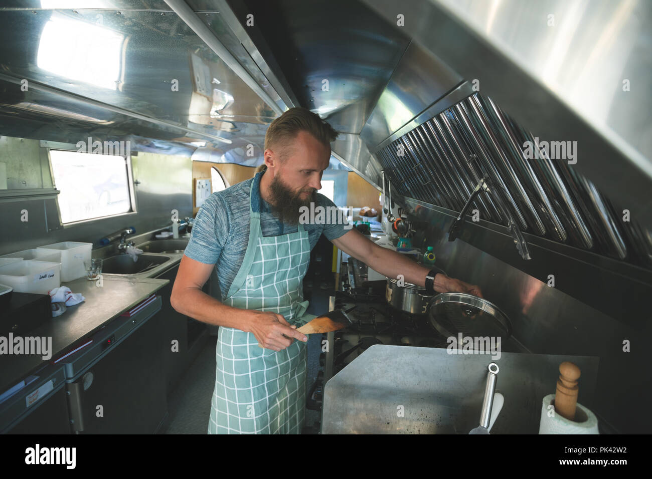 Waiter preparing food in food truck Stock Photo