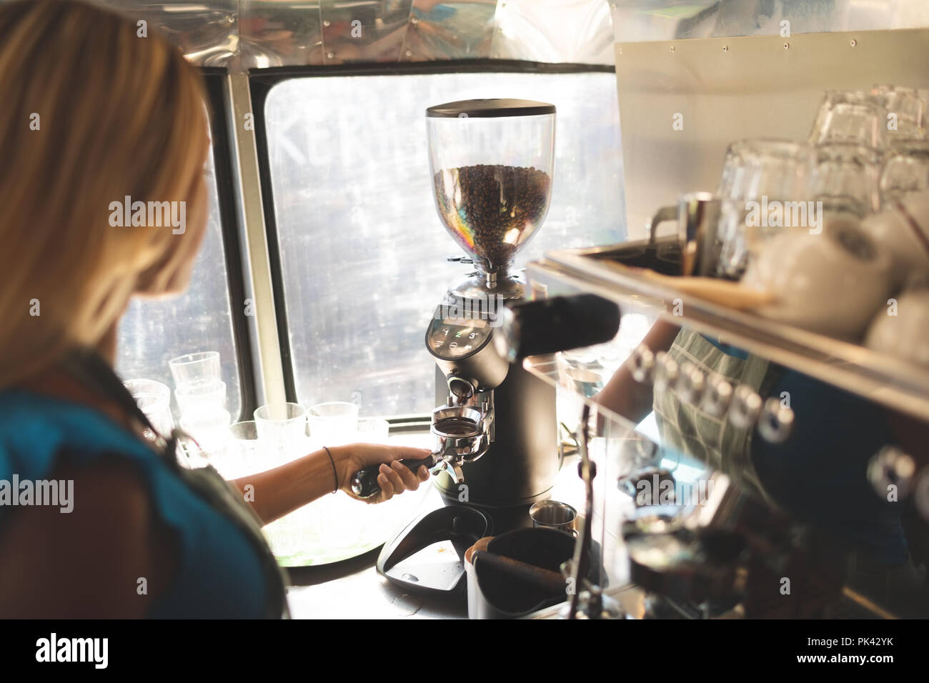 Female waiter preparing coffee in food truck Stock Photo