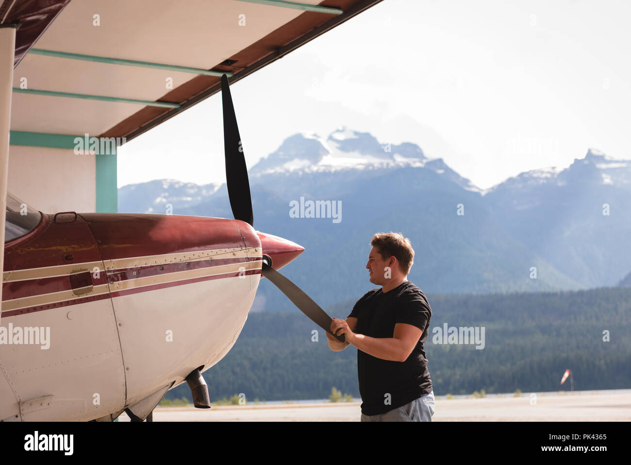 Mechanic checking aircraft propeller Stock Photo