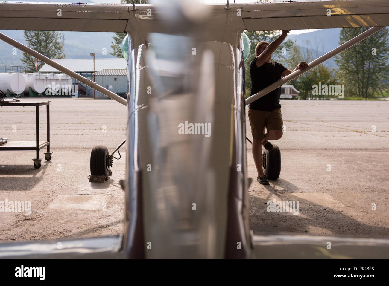Mechanic servicing aircraft wing Stock Photo