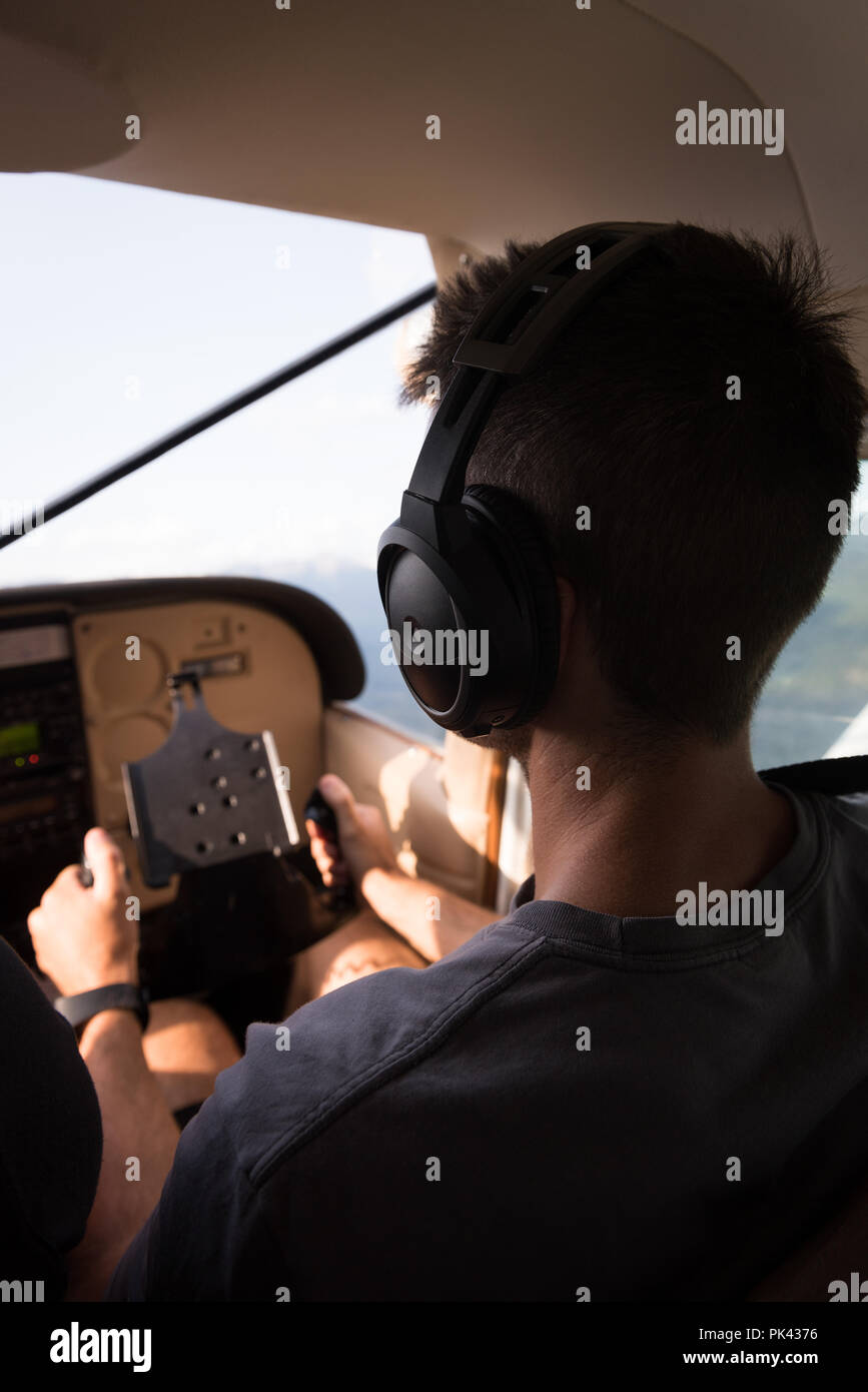 Pilot flying aircraft in cockpit Stock Photo