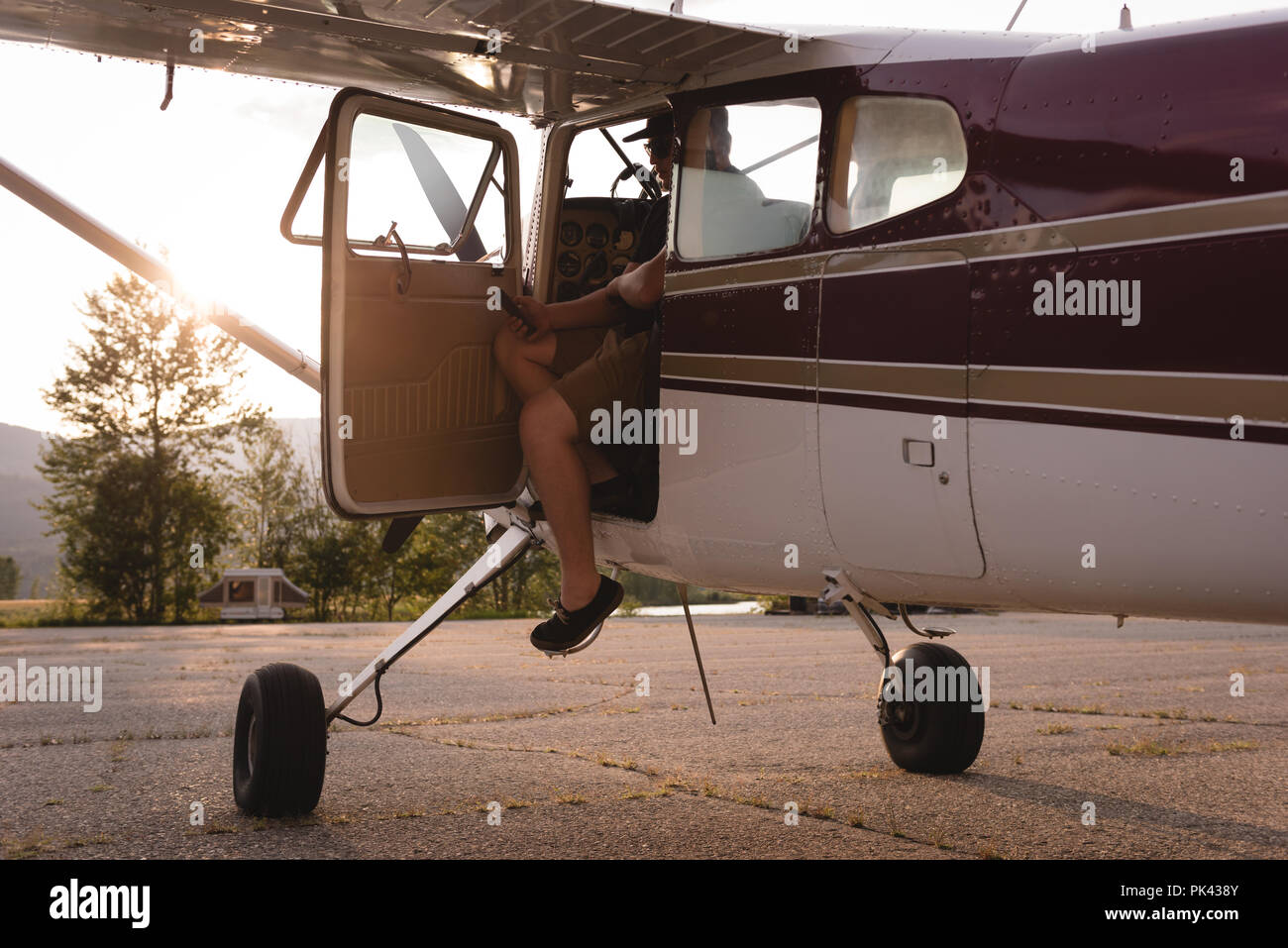 Pilot coming out from aircraft Stock Photo