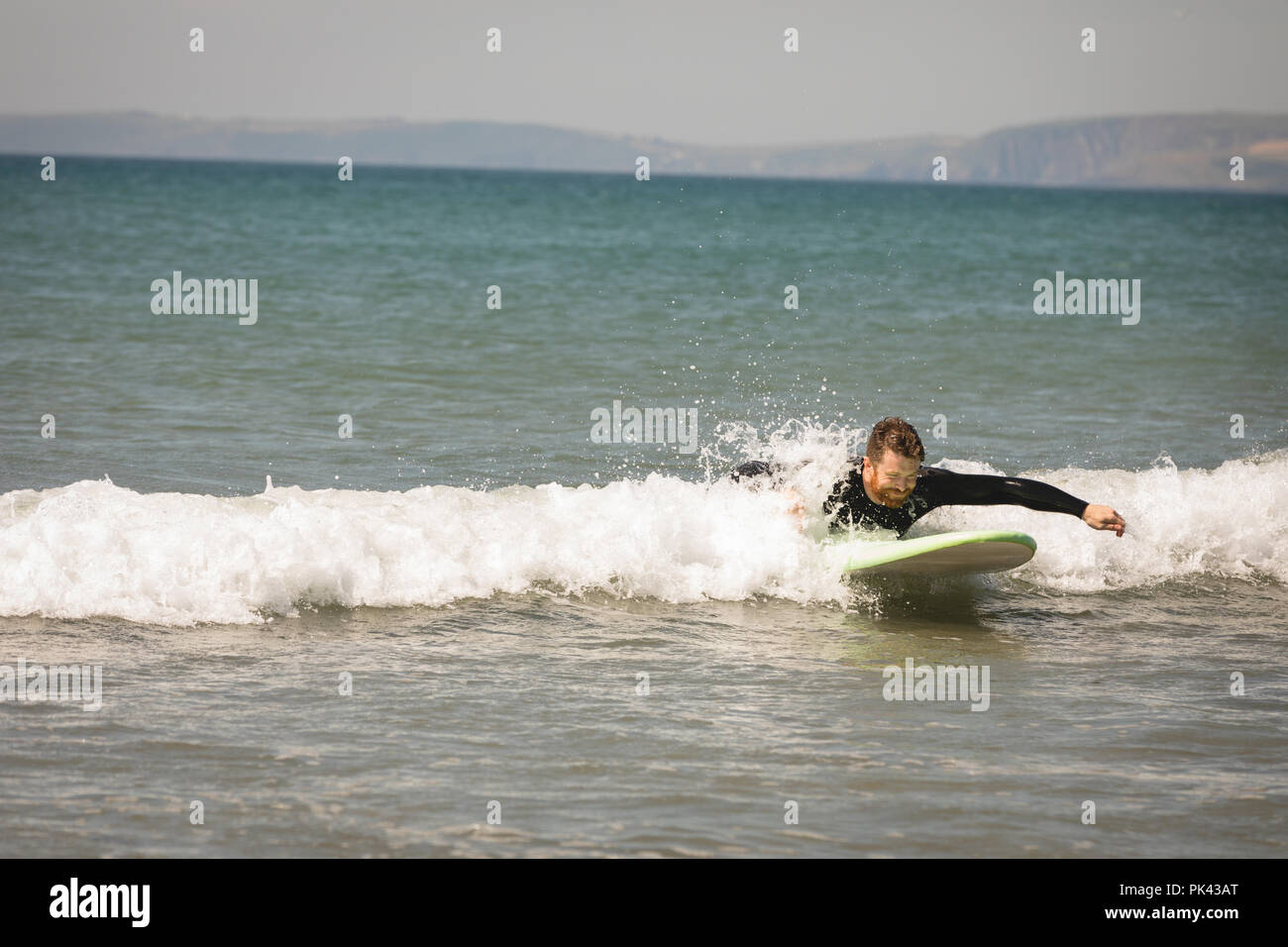 Surfer surfing on seawater Stock Photo