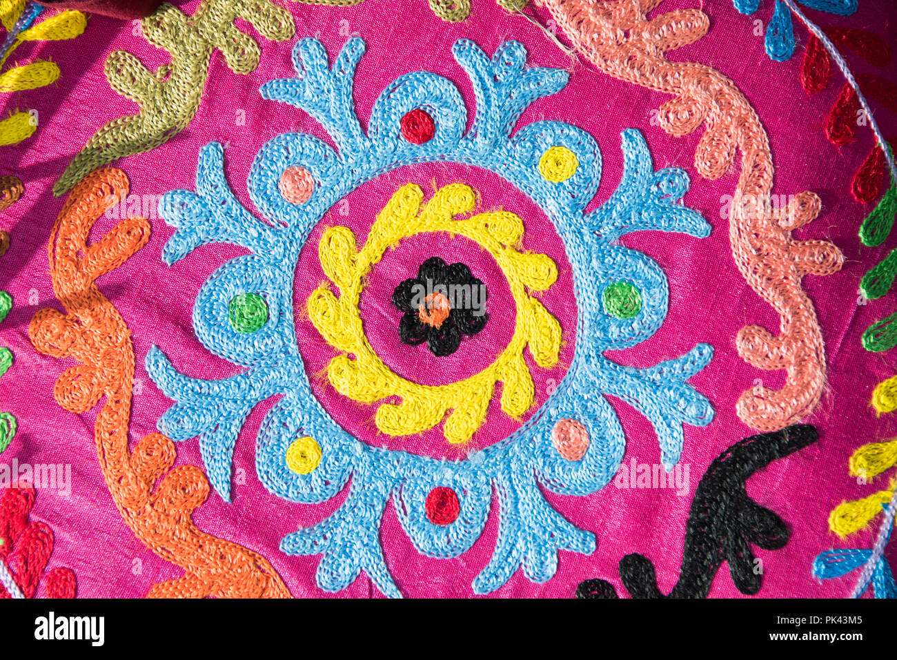 Chepstow, Wales – Aug 16: beautiful embroidered stitched colourful patterned cushion cover for sale on 16 Aug 2015 at the Green Gathering Festival Stock Photo
