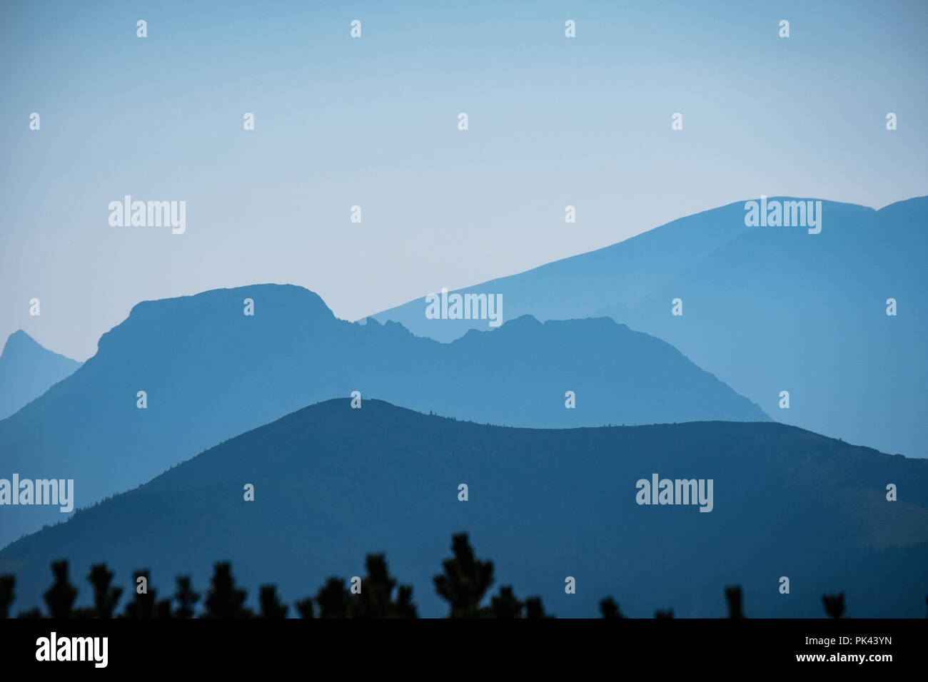 western carpathian mountain tops in autumn covered in mist or clouds ...