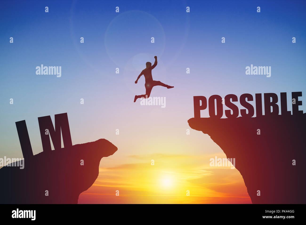 Man jumping on impossible text over cliff on sunset background Stock Photo