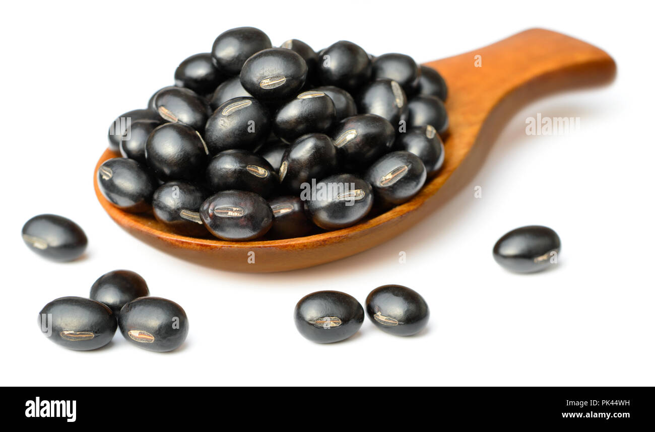 raw black bean in the wooden scoop, isolated on white Stock Photo
