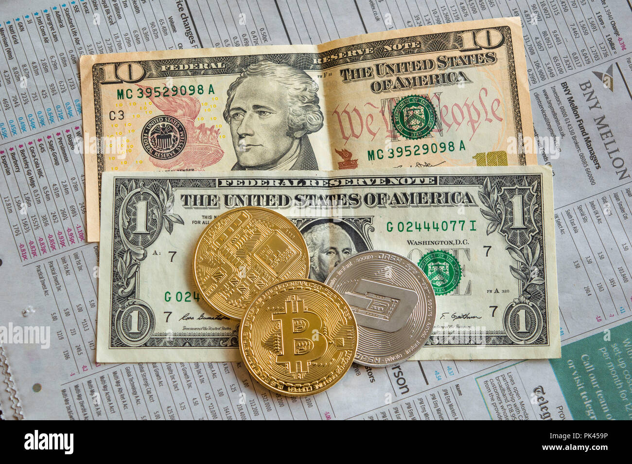 Golden bitcoins, silver dash and dollar notes on newspaper Stock Photo -  Alamy