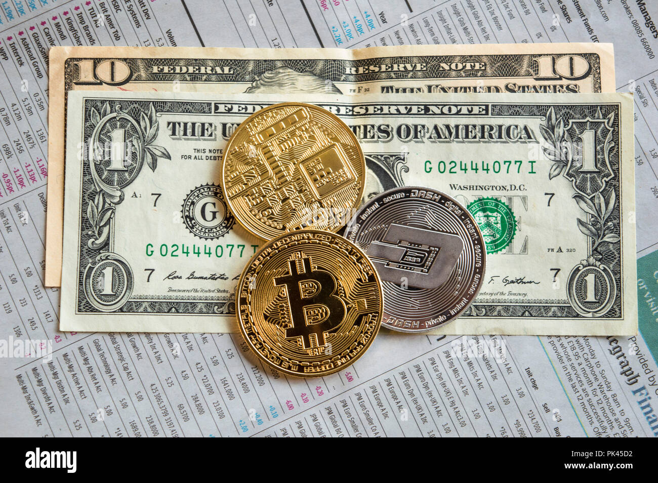 Golden bitcoins, silver dash and dollar notes on newspaper Stock Photo -  Alamy