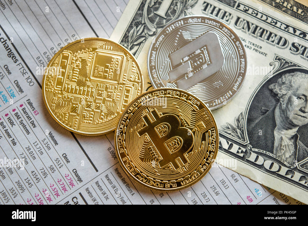 Golden bitcoins, silver dash and dollar notes on newspaper Stock Photo -  Alamy