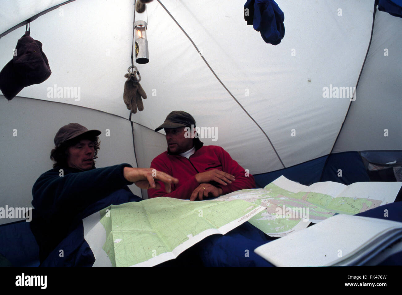 OutdoorSport38/121801 Climbers check over maps at their base camp on