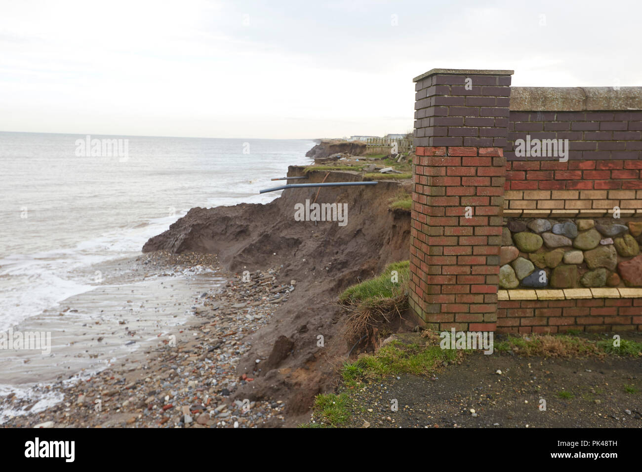 Coastal Erosion cliffs, remains of a caravan site that has collapsed into the North Sea, Ulrome, Skipsea, East Riding of Yorkshire, England, UK Stock Photo