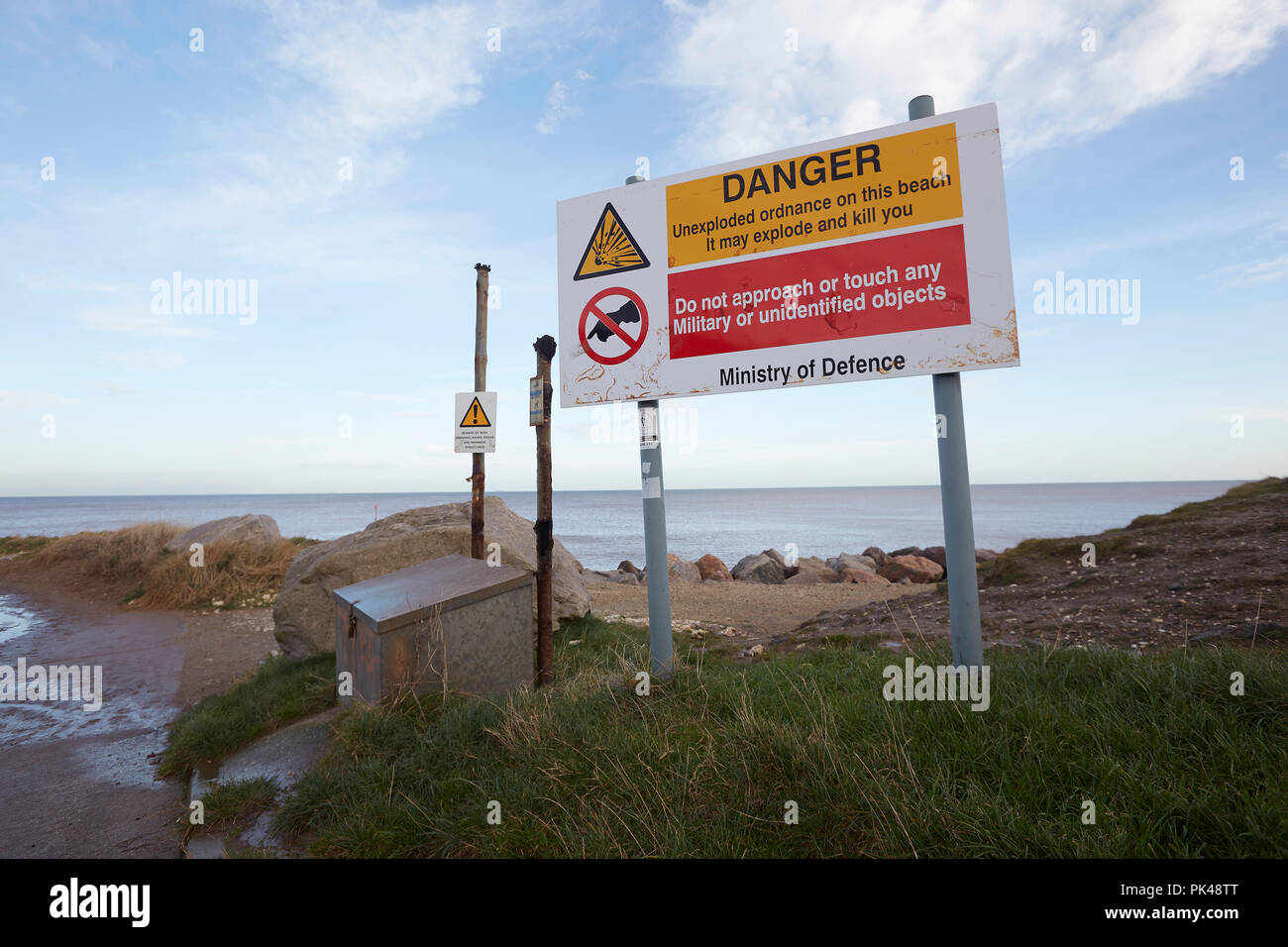 Ministry of Defence sign warning of unexploded ordnance on the beach, Mappleton, near Hornsea, East Riding of Yorkshire, UK Stock Photo