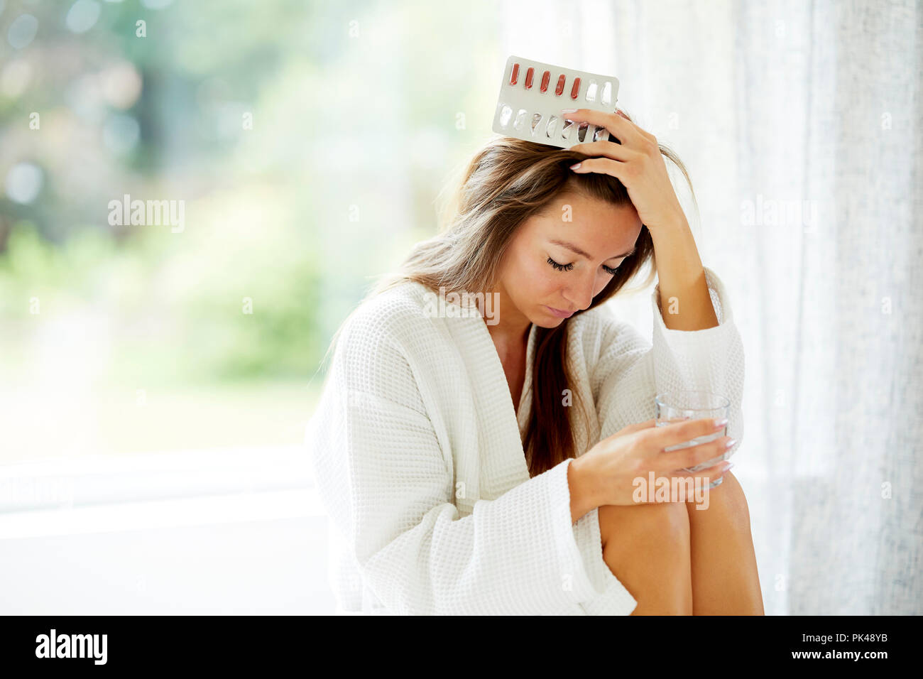 Woman holding packet of tablets Stock Photo
