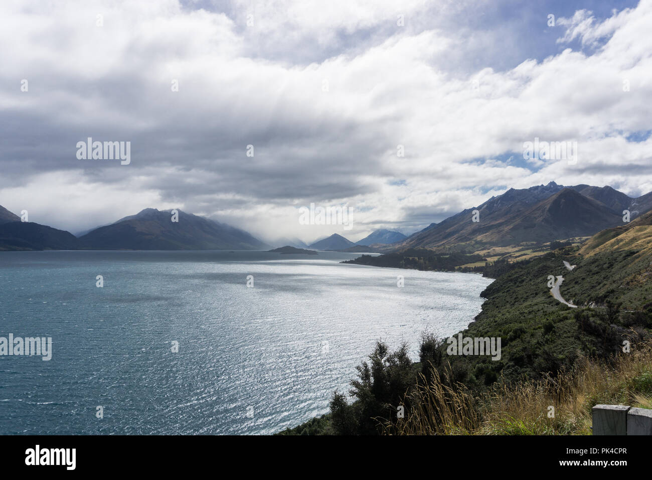 Mountain views in Glenorchy New Zealand Mystical Lake Blue Sky Foggy Stock Photo