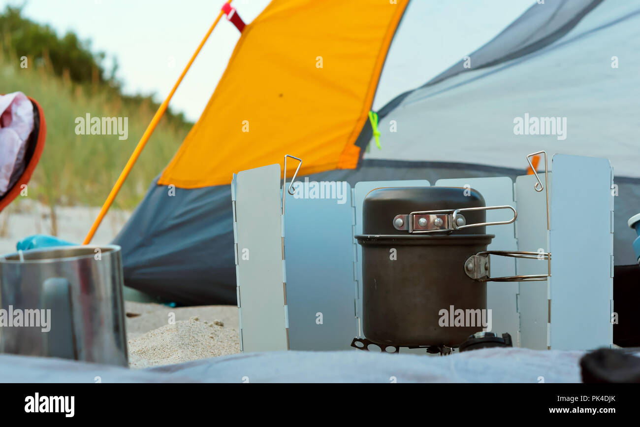 camping burner and tent, tourist gas burner and yellow tent Stock Photo