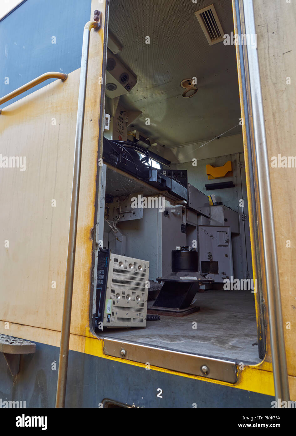Peering through and open door of the Drivers Cabin on a Dutch Passenger Train being stored for Recycling at a Container Port in Amsterdam, Holland. Stock Photo