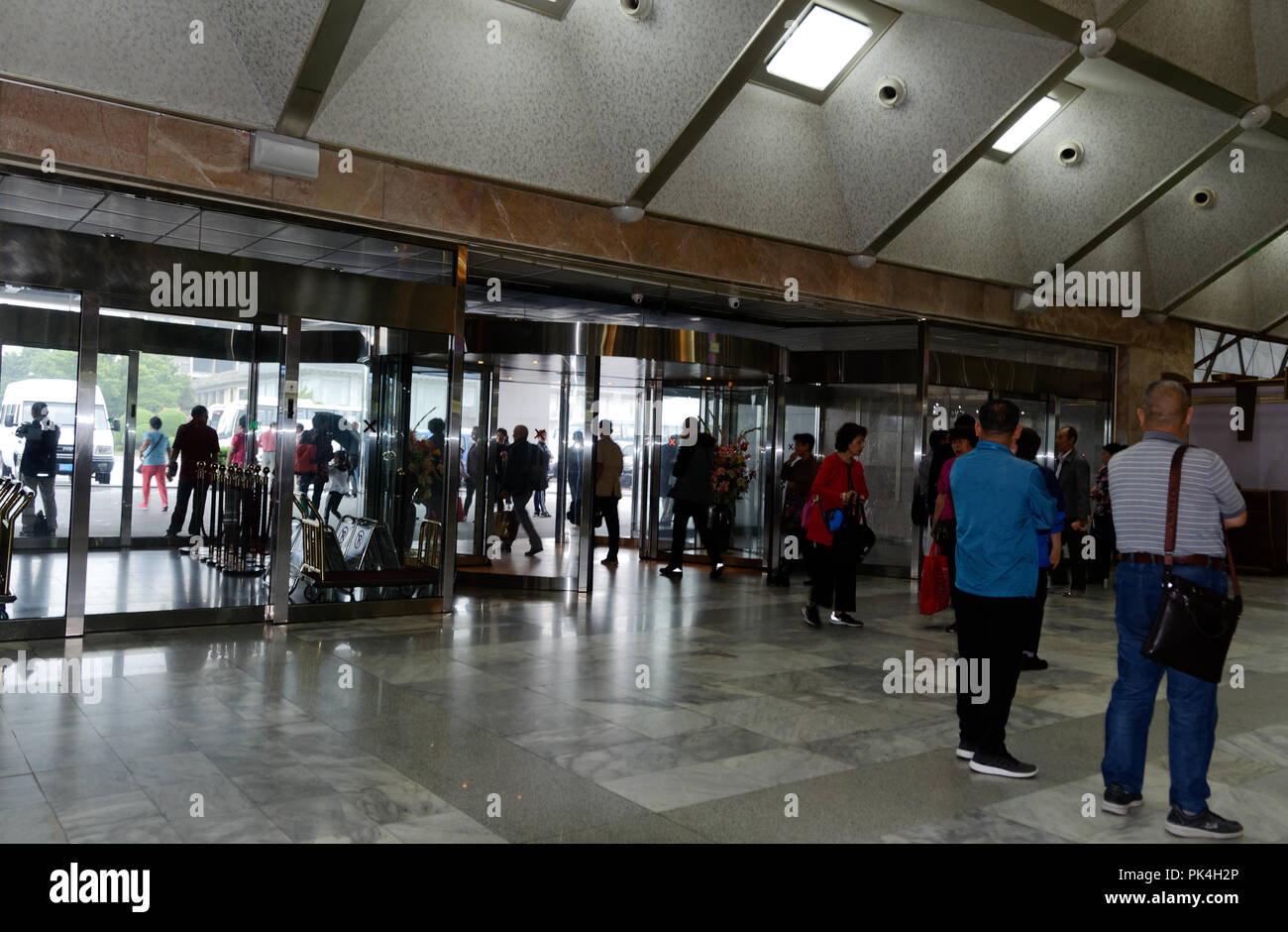 North Korea - Western and Chinese tourists in the foyer of the recption area, Yanggakdo International Hotel, Pyongyang Stock Photo