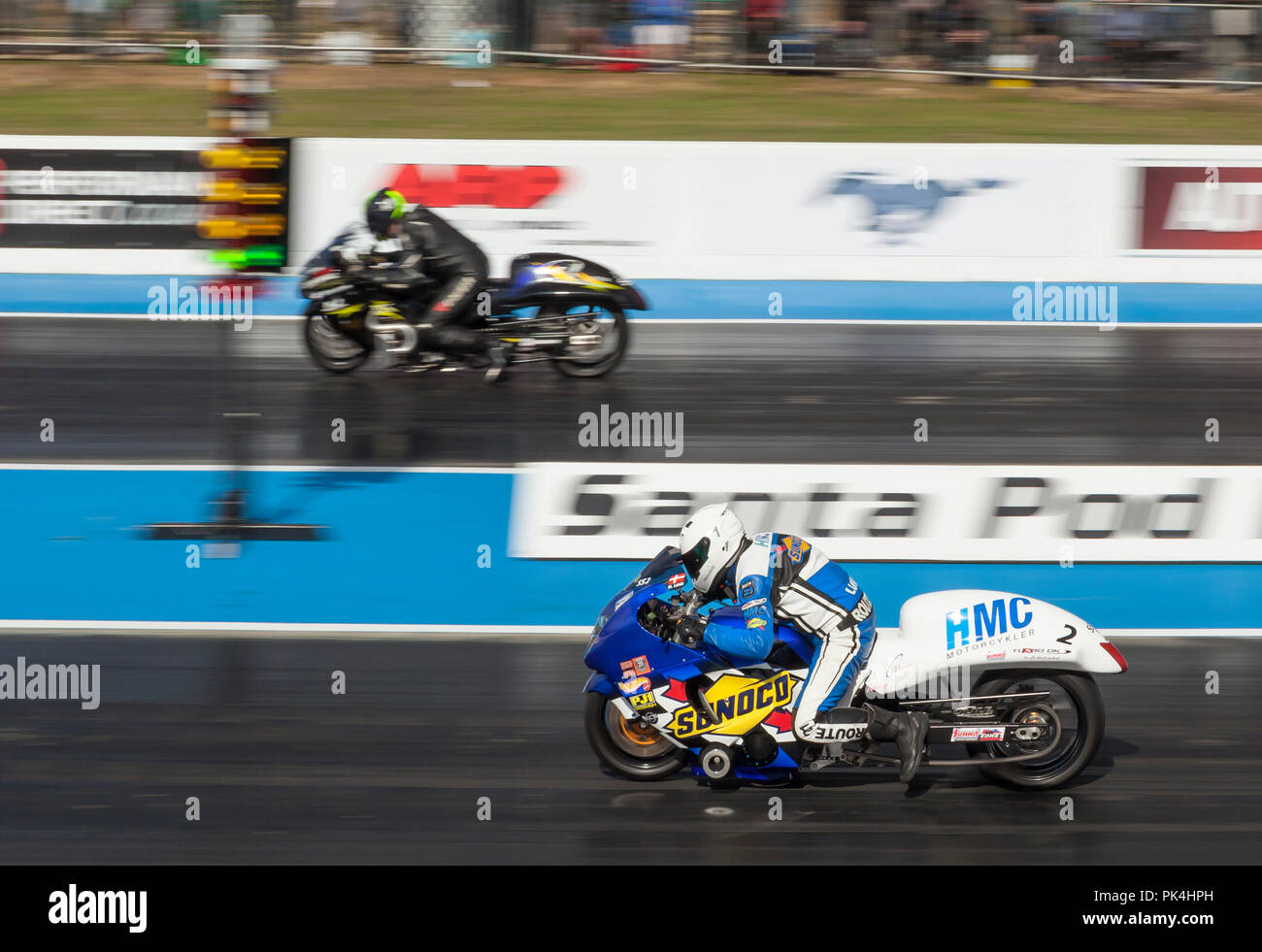 Super street drag racing at Santa Pod Raceway. Mogens Lund nearside v Garry Bowe far side, both riding Suzuki Hayabusa motorcycles. Stock Photo