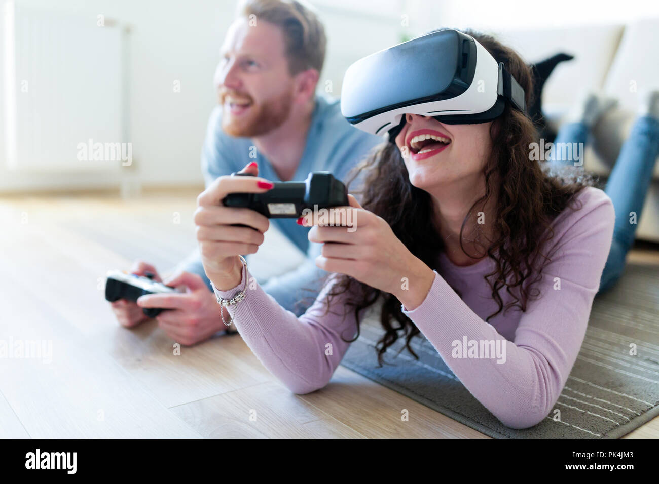 Young couple playing games with virtual reality headset Stock Photo