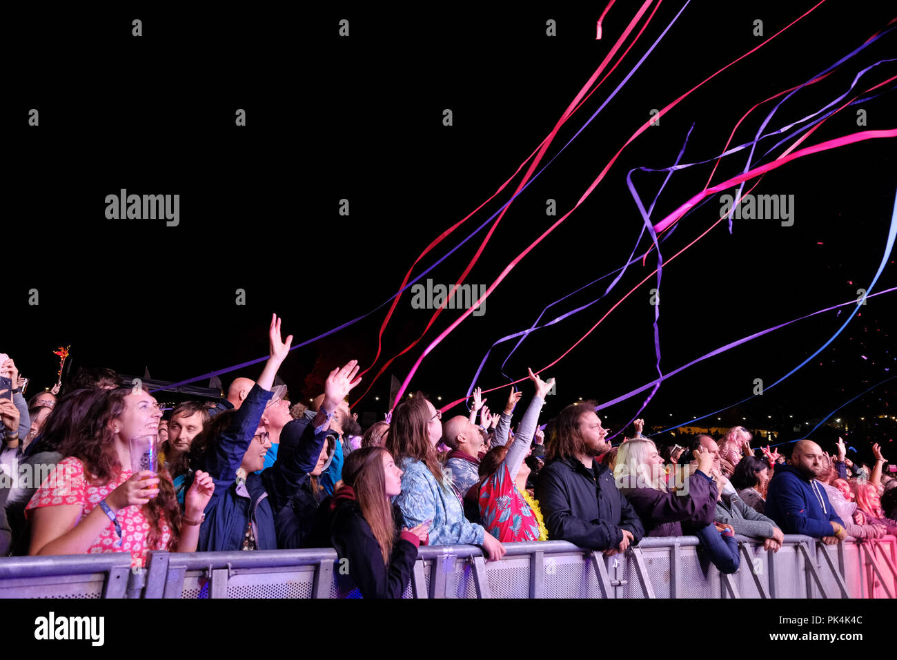 Streamers fire into the main stage crowd as Friendly Fires play the