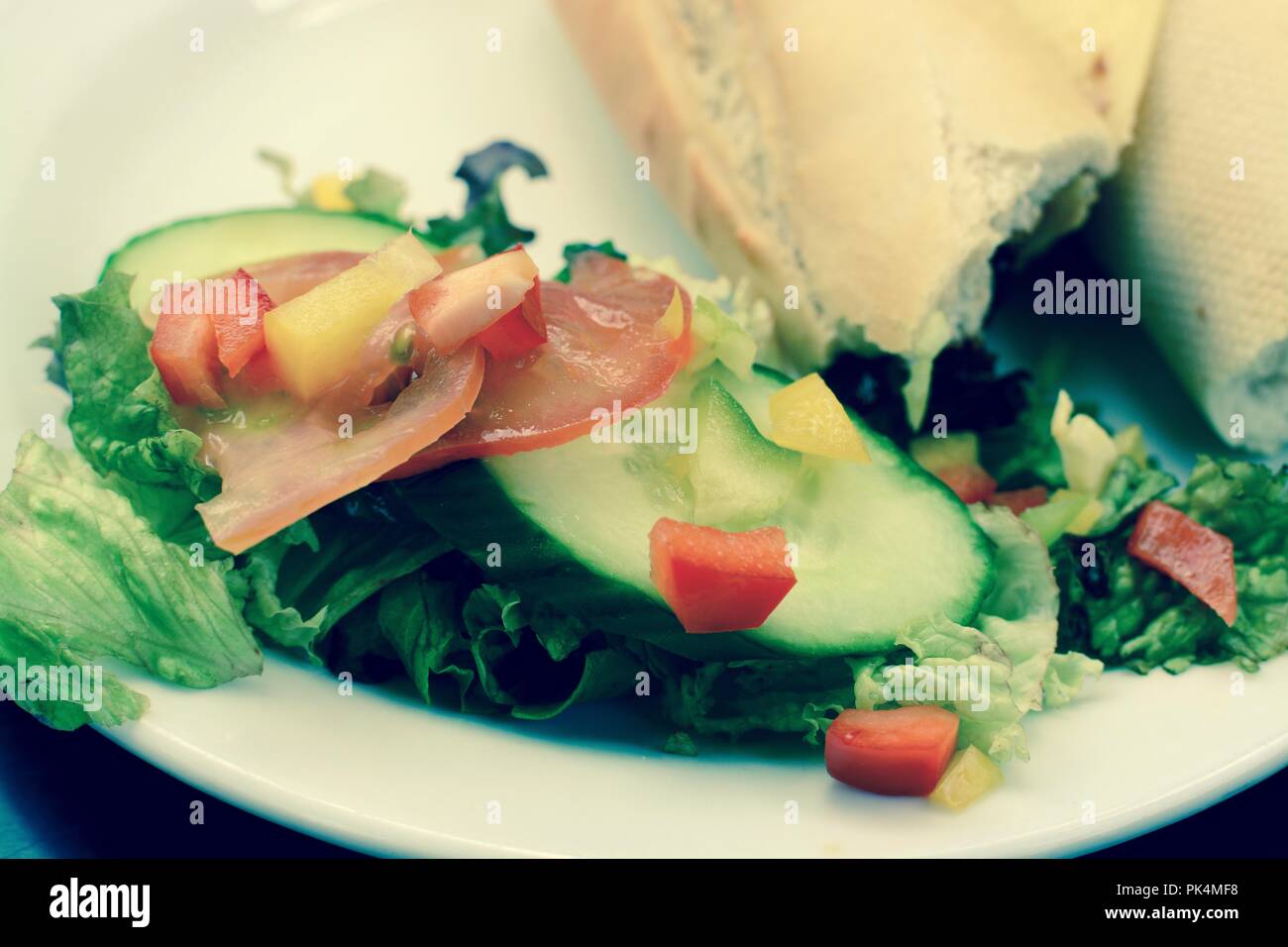 White baguette cheddar cheese and chutney sandwich with side salad, filter applied Stock Photo