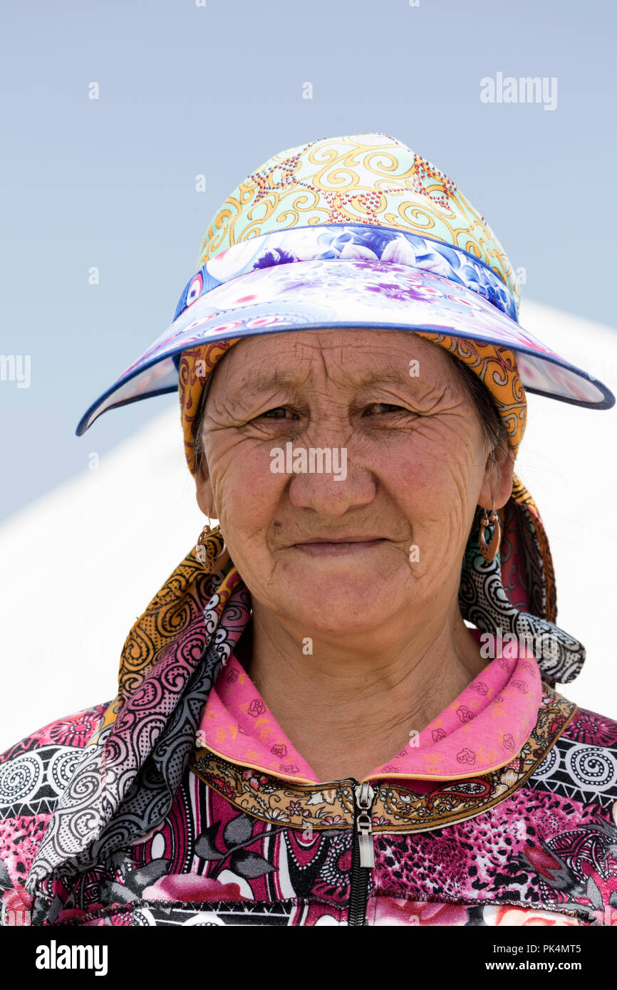 Song Kul, Kyrgyzstan, August 8 2018: Portrait of a beautiful Kyrgyz woman wearing a hat at Song Kul lake in Kyrgyzstan Stock Photo