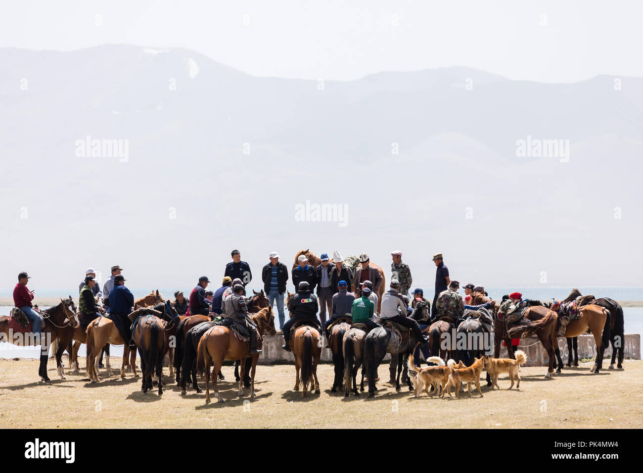 Song Kul, Kyrgyzstan, August 8 2018: Many Kyrgyz people meet with their horses at Song Kul Lake in Kyrgyzstan for a debate Stock Photo