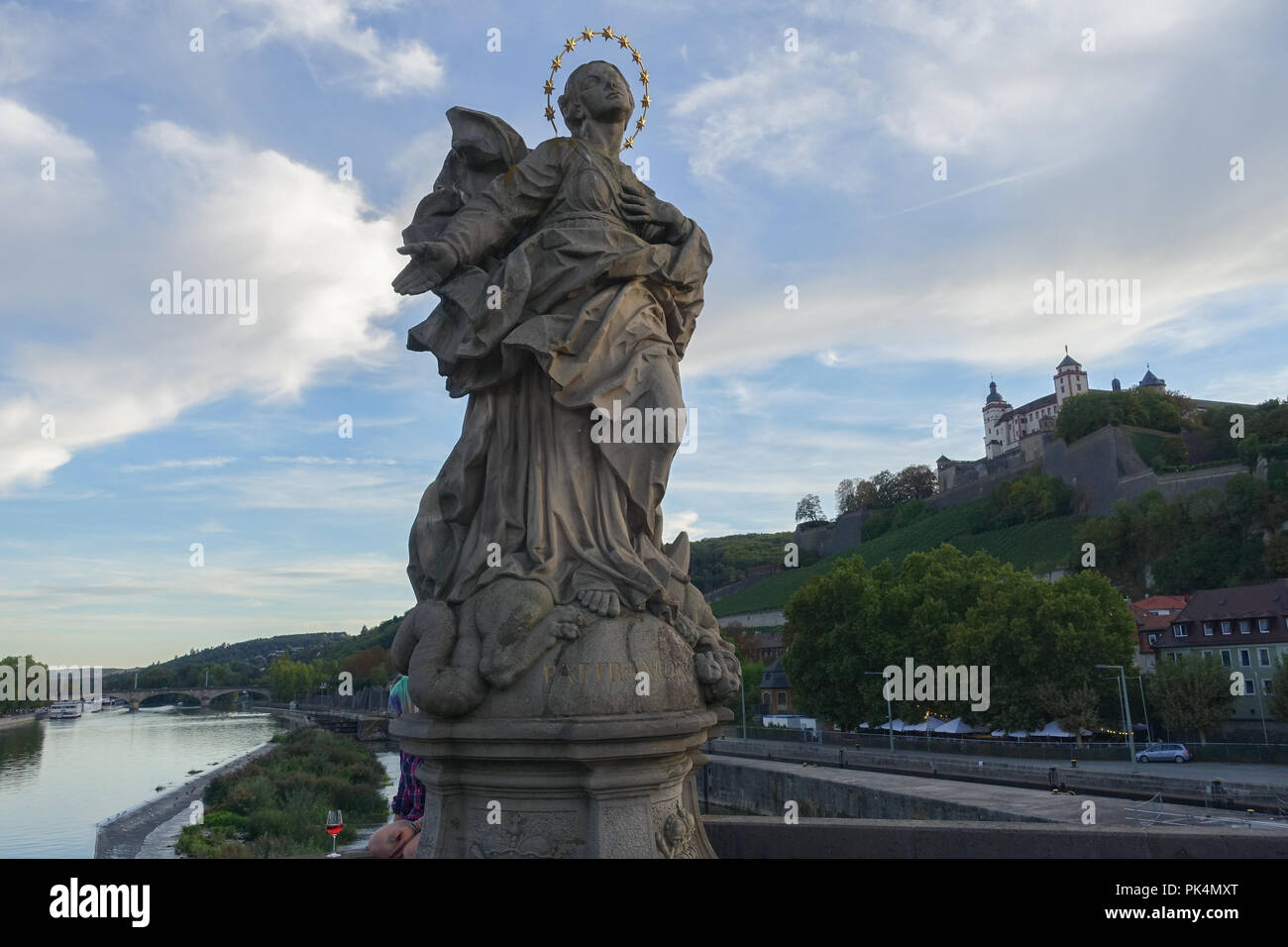St. Kilian Statue on the Alte Mainbrücke, Würzburg with Marienberg Fortress in background Stock Photo