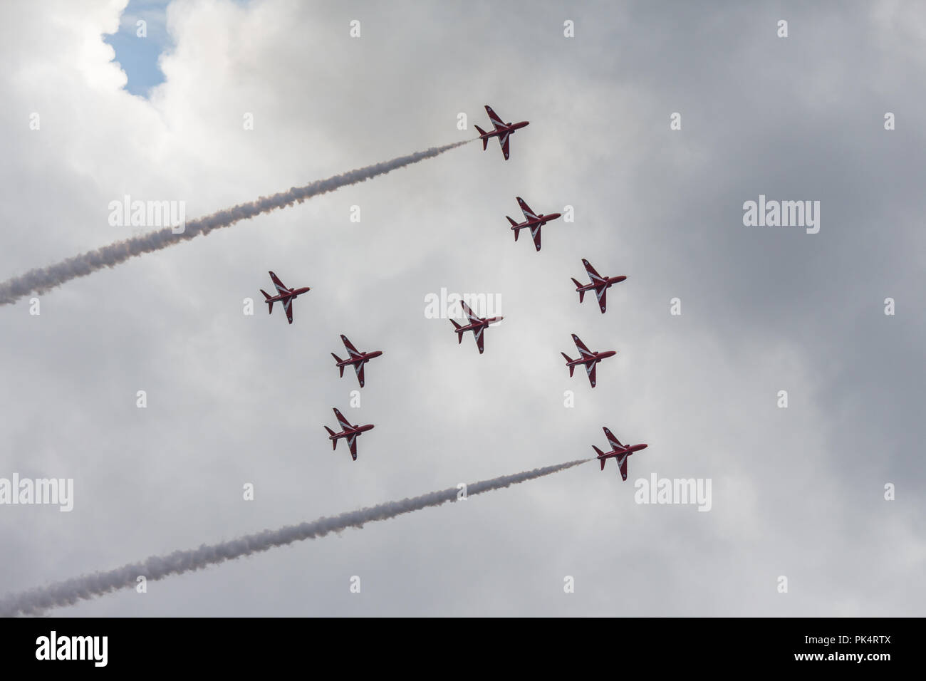 Aircraft Formation - The Red Arrows, the Royal Air Force aerobatics team, on display at airshow over Carrickfergus Castle, County Antrim, N.Ireland. Stock Photo