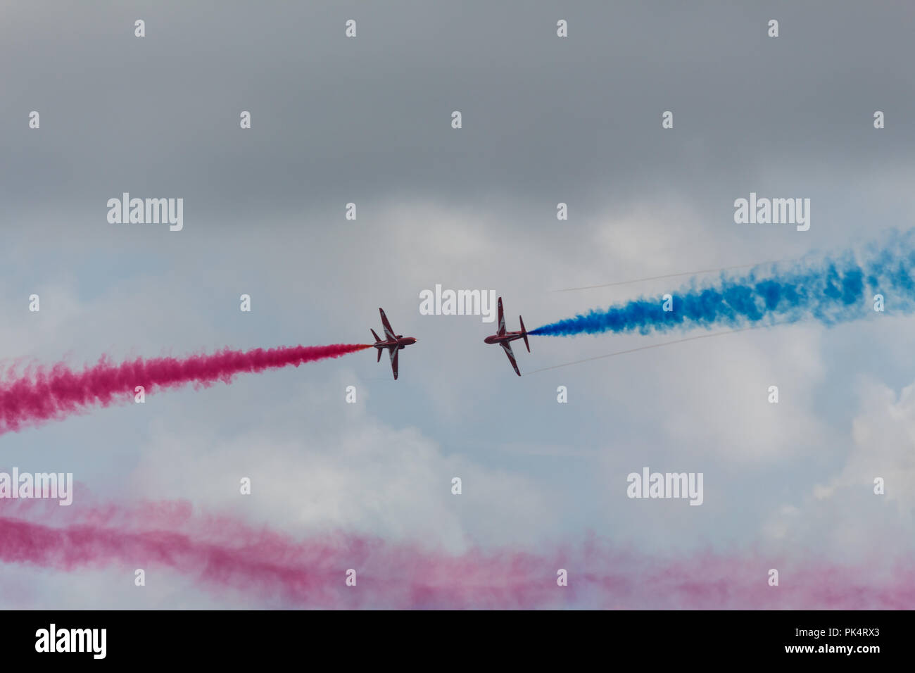 Closing in - The Red Arrows, the Royal Air Force aerobatics team, on display at airshow over Carrickfergus Castle, County Antrim, N.Ireland. Stock Photo