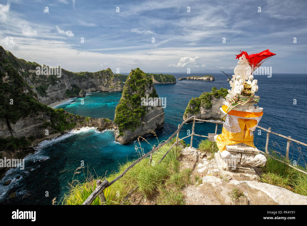 Red fabric blows in the wind from the top of a Balinese Hindu shrine on Nusa Penida. Stock Photo
