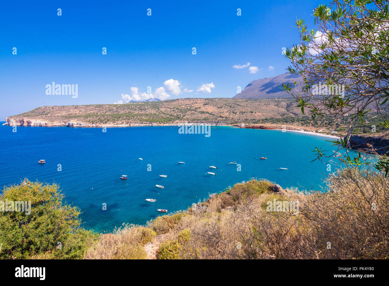 The gulf outside of the amazing caves of Dirou with fishing boats and turquoise waters, Peloponnese, Greece. Stock Photo