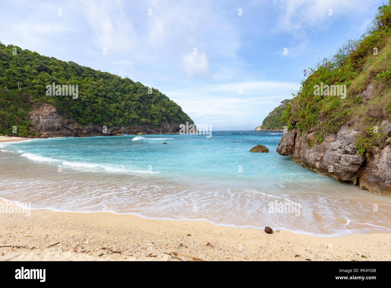 Calm surf at Atuh beach on Nusa Penida an island off of Bali in Indonesia. Stock Photo