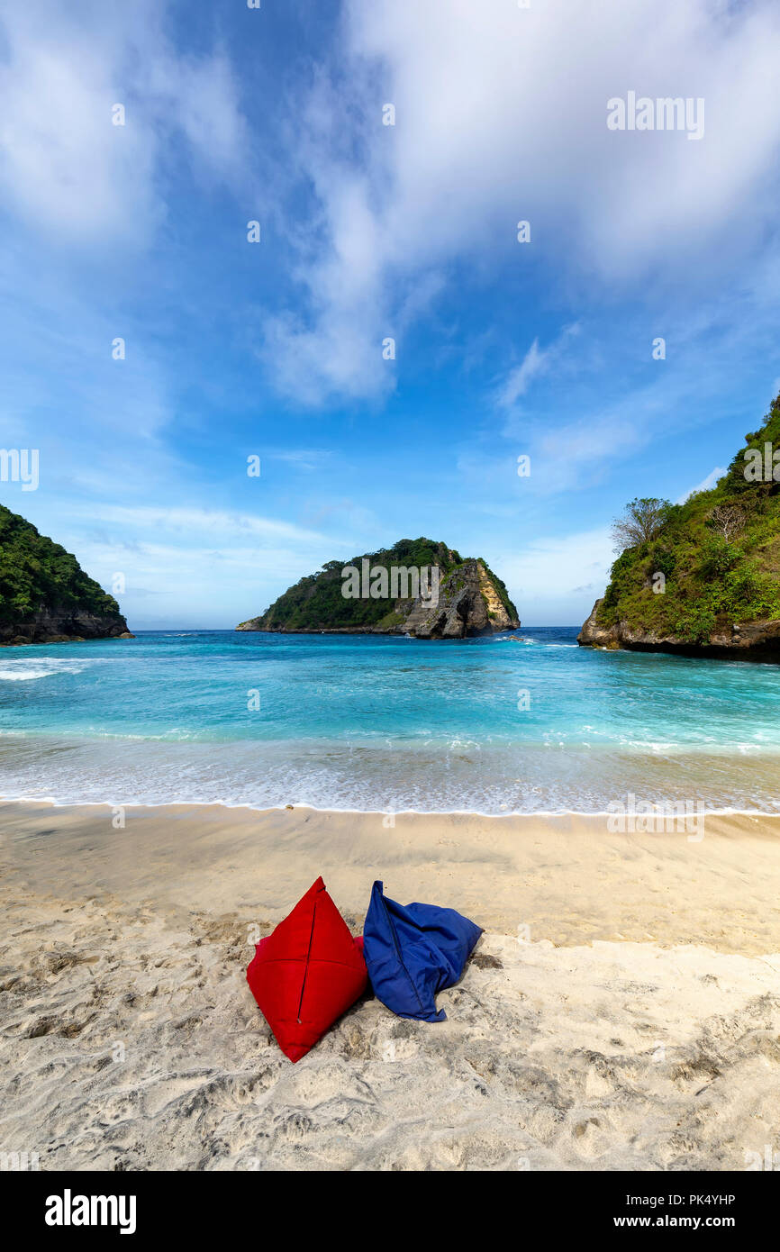 Portrait view of two empty bean bag chairs on the beautiful Atuh Beach on Nusa Penida. Stock Photo