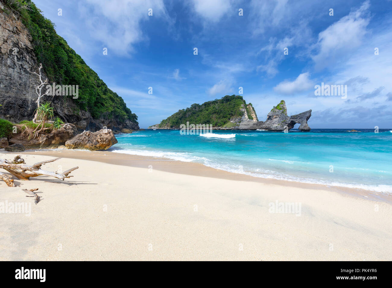 Small waves crash at the end of Atuh Beach in Nusa Penida, a small island near Bali, Indonesia. Stock Photo