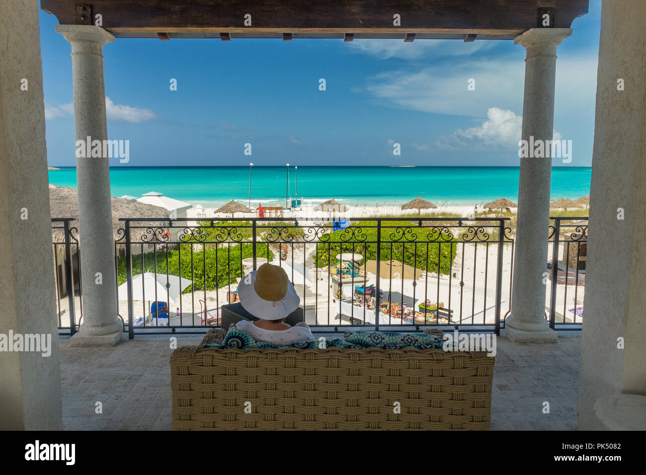 Beach hat woman enjoying view of palapas at the beach in Great Exuma, Bahamas Stock Photo
