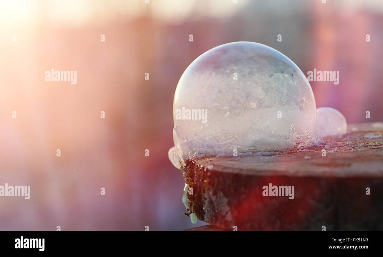 Soap bubbles freeze in the cold. Winter soapy water freezes in t Stock