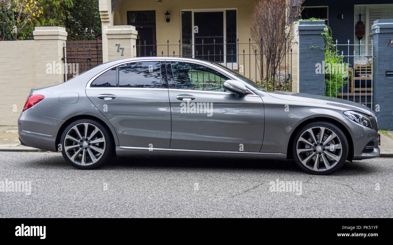 A grey Mercedes Benz C250 parked on the street. Stock Photo