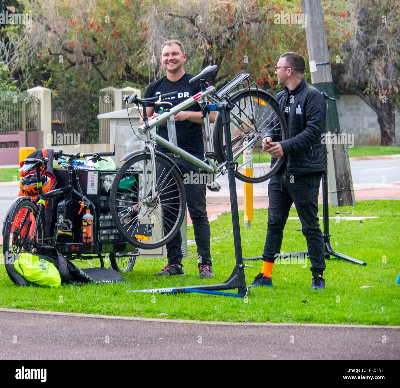 Bike mechanics servicing a bicycle in a park, Perth WA, Australia. Stock Photo
